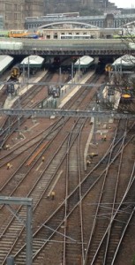 Busy railway station with buses traversing the railway via Victorian bridges